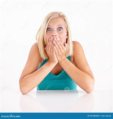 Shes Been Left Speechless Portrait Of A Blonde Woman Covering Her Mouth In Awe Stock Photo