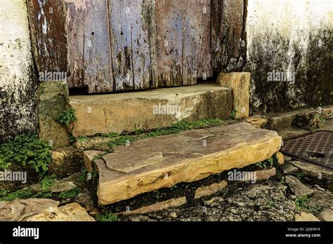 Wooden Door And Stairs And Stone Sidewalk In An Old House Stock Photo