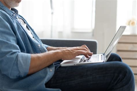 Premium Photo Remote Job Grey Haired Mature Handsome Caucasian Man Working On Laptop Sitting