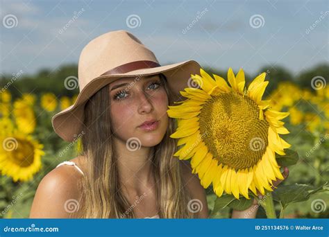 A Lovely Blonde Model Poses Outdoor While Enjoying The Summer Weather In A Field Of Wild