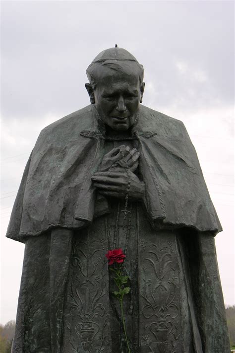 Bronze statue of a solemn figure with rosary beads Free Stock Photo ...
