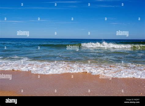 Beach Shore Water Coming In Sand Ocean Landscape Sunny Daytime Vacation