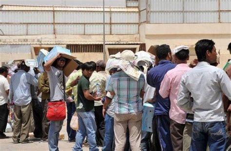 A Group Of People Standing Around Each Other In Front Of A Building