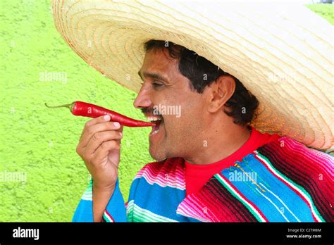 Mexican Man Poncho Sombrero Eating Red Chili Hot Pepper Mexico Stock Photo Alamy