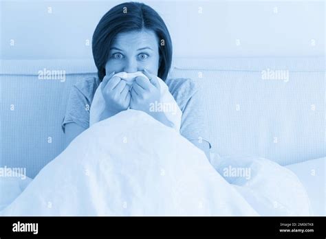Young Woman Sitting In Bed And Is Scared And Terrified Stock Photo Alamy