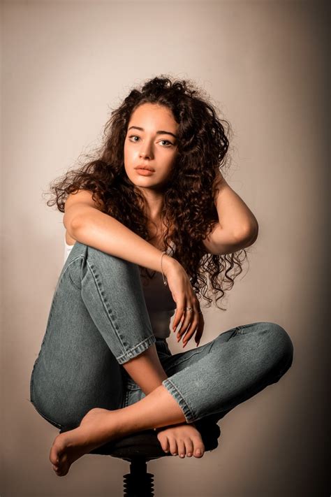 Tess Curly Chairs Sitting Pose Legs Jeans Brunette Girl HD Phone