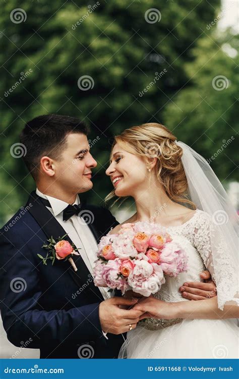 Handsome Smiling Groom Hugging Sensual Blonde Beautiful Bride In Stock Photo Image Of Groom