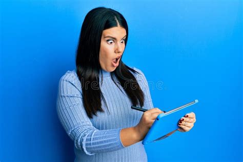 Beautiful Brunette Woman Using Touchpad Drawing On Screen In Shock Face