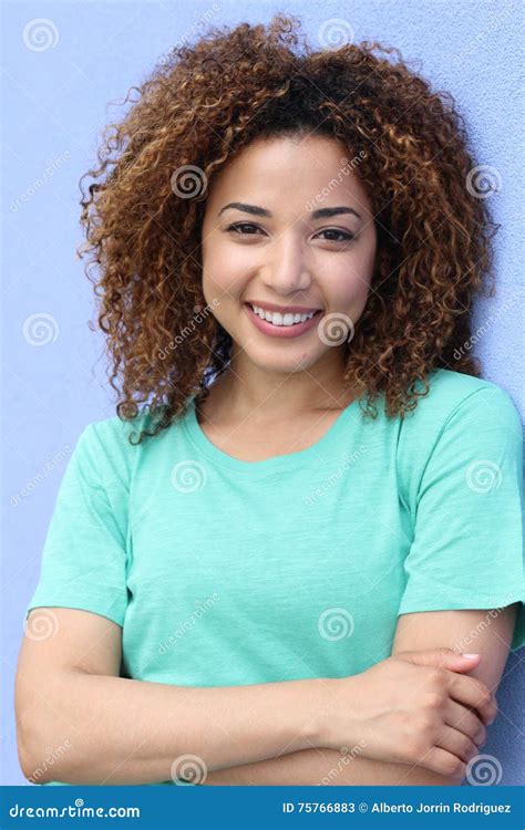 Ragazza Latina Con Il Ritratto Sorridente Biondo Di Stile Di Capelli Di Afro Su Un Fondo Blu