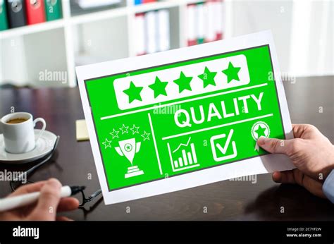 hand holding  paper showing quality concept stock photo alamy