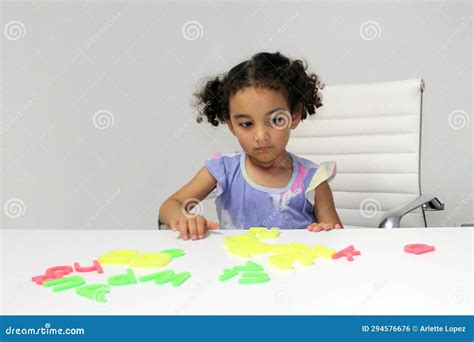 8 Year Old Latina Girl In Park With Big Metallic Balloon And Jumping Outdoors Royalty Free Stock