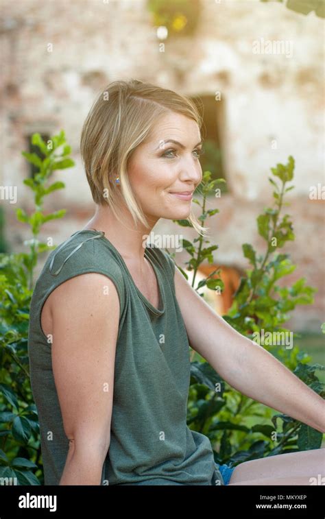 Beautiful Happy Blonde Woman Smiling And Enjoying Her Time Outside In