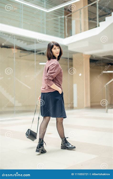 Mature Woman Walking Confidently In Mall While Looking At Camera Stock Image Image Of