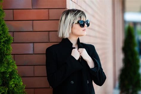 Premium Photo Portrait Of A Beautiful Blonde Girl In A Black Jacket On A Brick Wall Background
