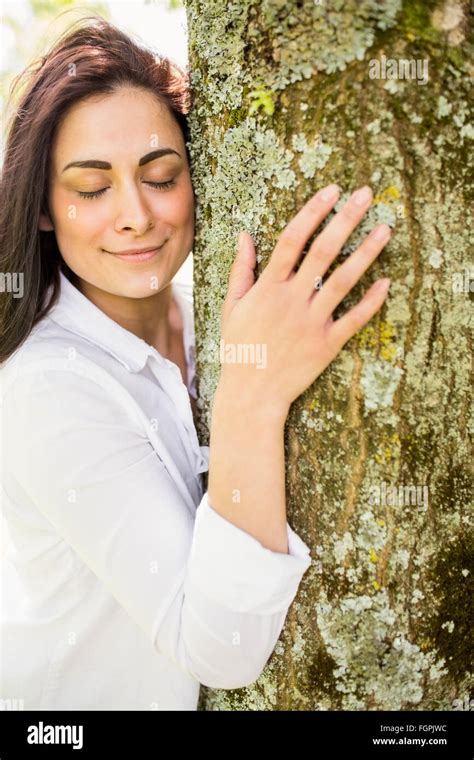 Beautiful Brunette Hugging A Tree Stock Photo Alamy