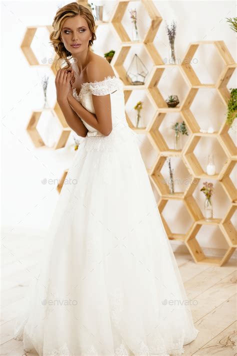 Beautiful Sexy Blonde Bride Posing In Wedding Dress In White Room Stock Photo By Nikita Karchevskyi
