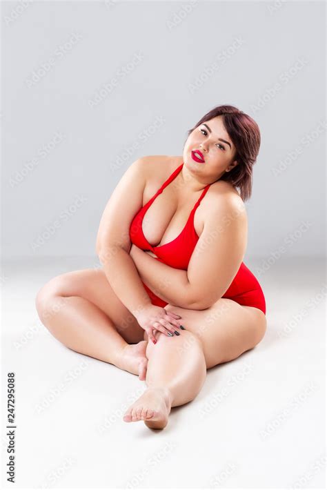Plus Size Fashion Model In Red Lingerie Fat Woman In Underwear On Gray Studio Background