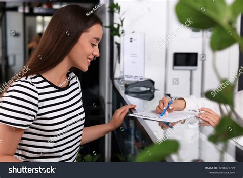 Happy Young Woman Registering Reception Desk Stock Photo 2204672799 ...