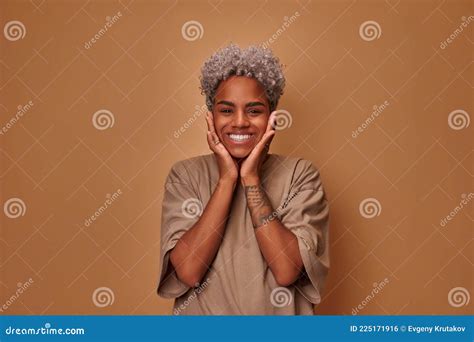 Happy Woman With Blonde Hair And Gentle Smile Holding Hands Under Chin