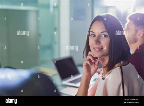 Portrait Confident Brunette Businesswoman In Meeting Stock Photo Alamy