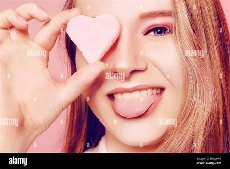 Valentine S Day A Girl On A Pink Background Closes Her Eye With A Heart The Blonde Smiles