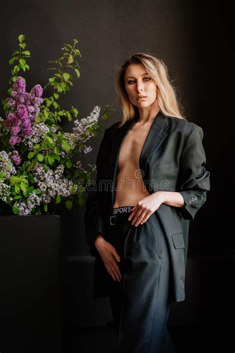 A And Beautiful Blonde Woman In A Jacket On A Naked Body In A Dark Room Stock Photo Image Of