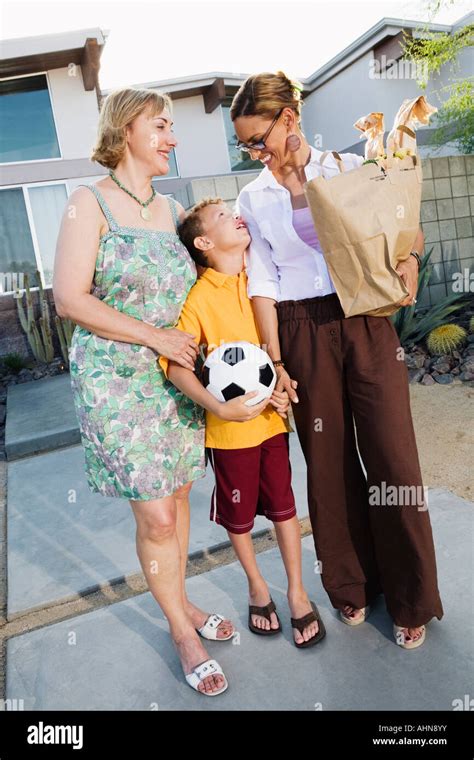 Lesbian Couple Walking With Their Son Stock Photo Alamy
