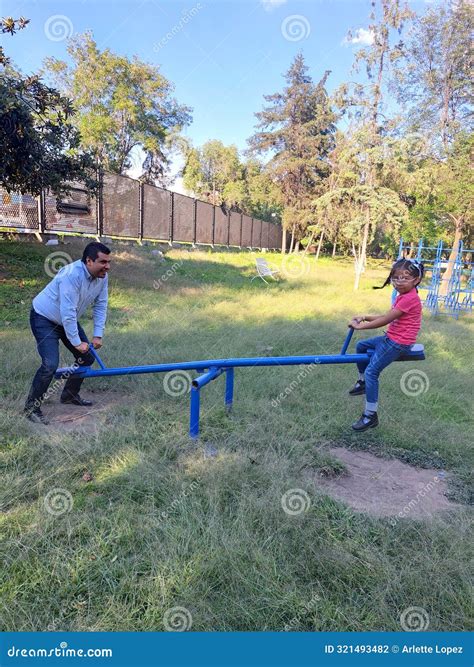 Divorced Dad Plays With His Brunette Latina Daughter On The Seesaw In