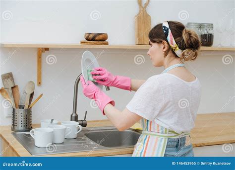 Junge Brunette Frau in Einer K che W scht Schalen Und Teller Stockbild Bild von inländisch