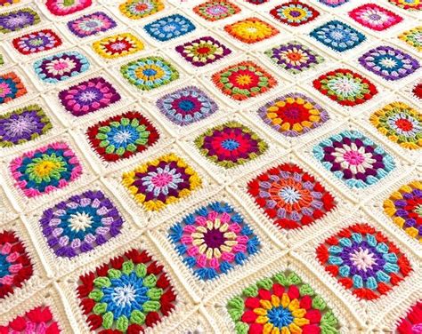 A Crocheted Granny Blanket With Many Different Colors And Shapes On Top