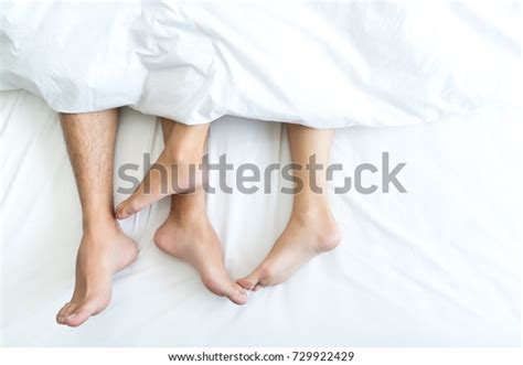 Close Male Female Feet On Bed Loving Couple Having Sex Under White Sheets Bedroom Royalty