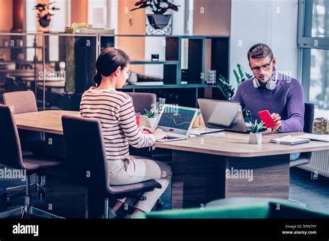 Concentrated Brunette Man Looking At Screen Of His Gadget Stock Photo Alamy
