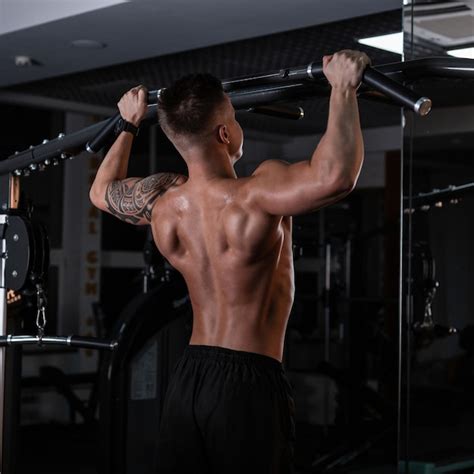 Premium Photo Strong Handsome Man Athlete With A Muscular Naked Back Pulls Up In The Sports Gym