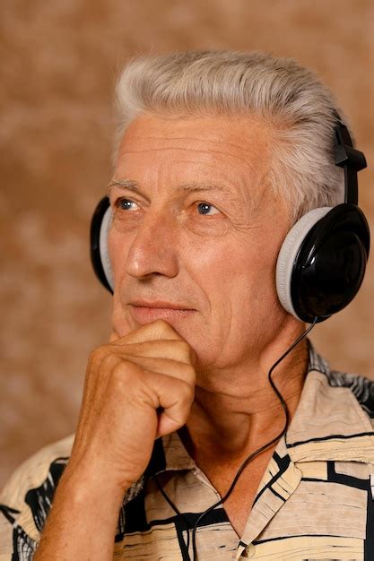 Premium Photo Close Up Portrait Of Senior Man Listening To Music In