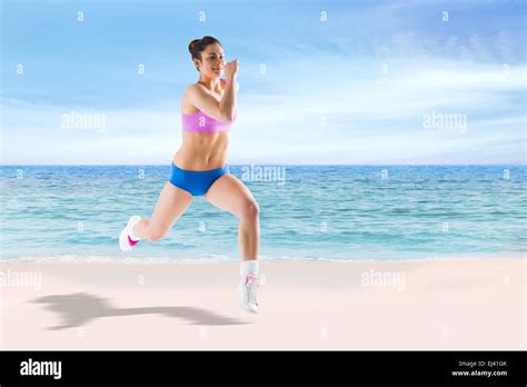 Composite Image Of Fit Brunette Running And Jumping Stock Photo Alamy