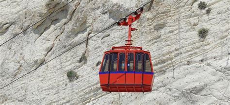 Red Funicular Car Against The Background Of White Rock Color Image