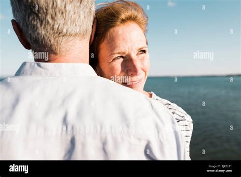 Smiling Mature Woman Hugging Man On Sunny Day Stock Photo Alamy