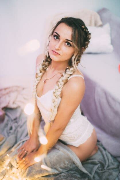 Premium Photo Sexy Girl With Two Pigtails In Lingerie Covered With A Plaid With Garlands On