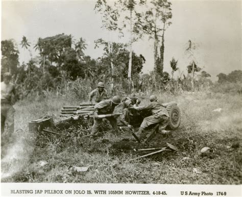 US Army soldiers firing a M101 howitzer at a Japanese pillbox, Jolo ...