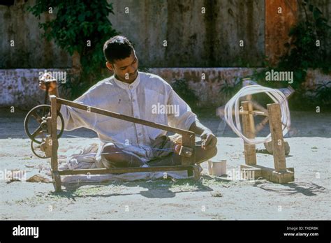 young boy spinning cotton yarn  charkha gujarat india asia stock