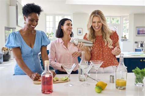 Three Mature Female Friends At Home Having Fun Mixing Cocktails Together Stock Photo Image Of