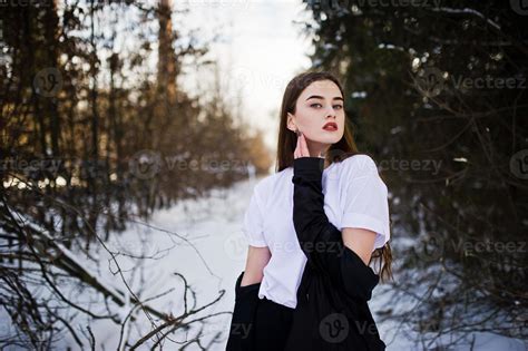 Fashionable Long Legs Brunette Model In Long Black Cloak Posed Outdoor At Winter Day