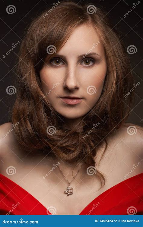 Authentic Brunette Model Girl With Nude Makeup And With Trendy Hairstyle In A Red Short Dress
