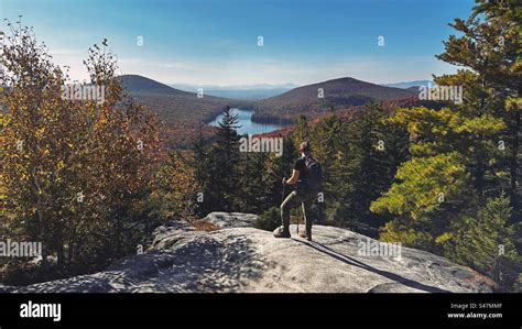 Hiker overlooking fall foliage in Vermont Stock Photo - Alamy