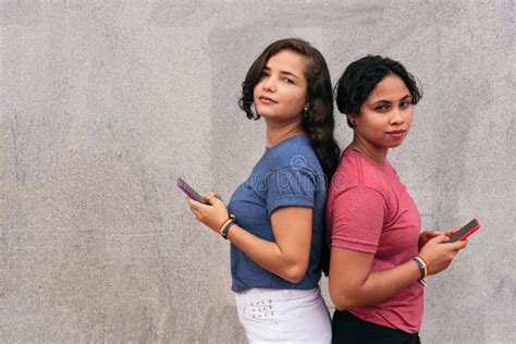 Latin Lesbian Couple With Cell Phone On The Street Stock Photo Image Of People Togetherness