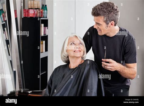 Female Client And Hairdresser Looking At Each Other Stock Photo - Alamy