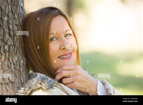 Portrait Attractive Beautiful Mature Woman Sitting Happy Relaxed With Friendly Smile Outdoors