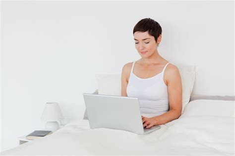 Premium Photo Charming Brunette Using A Laptop