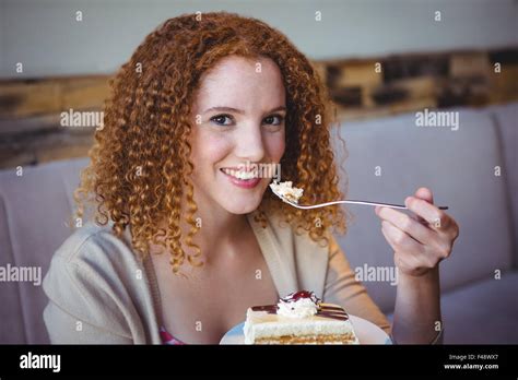 Portrait Of A Happy Pretty Brunette Eating A Cake Stock Photo Alamy