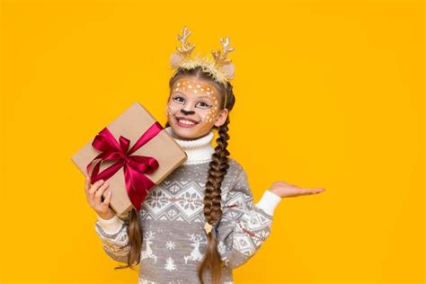 Premium Photo A Little Girl Dressed In A Festive Deer Costume With